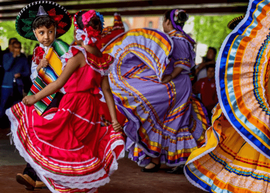Mexican flags and dancers celebrating Cinco de Mayo in Puebla, Mexico