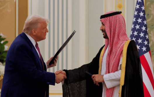 Donald Trump and Crown Prince Mohammed bin Salman shake hands in Riyadh after announcing a $600B U.S.-Saudi investment and arms agreement.