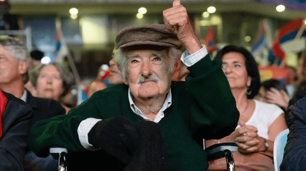 José Mujica seated at his modest Montevideo home, wearing casual clothes, reflecting his reputation as the world’s humblest president.