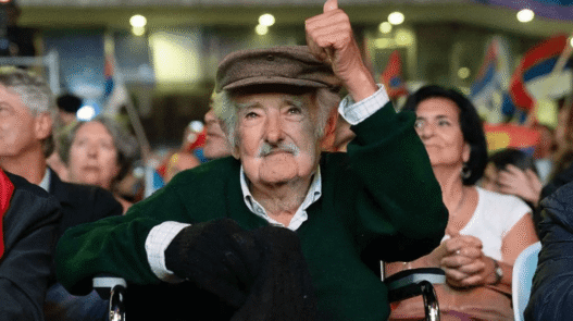 José Mujica seated at his modest Montevideo home, wearing casual clothes, reflecting his reputation as the world’s humblest president.