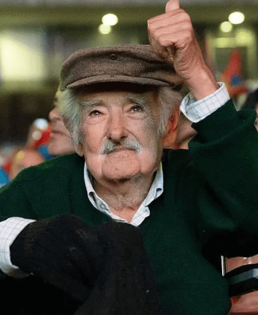 José Mujica seated at his modest Montevideo home, wearing casual clothes, reflecting his reputation as the world’s humblest president.