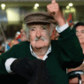 José Mujica seated at his modest Montevideo home, wearing casual clothes, reflecting his reputation as the world’s humblest president.