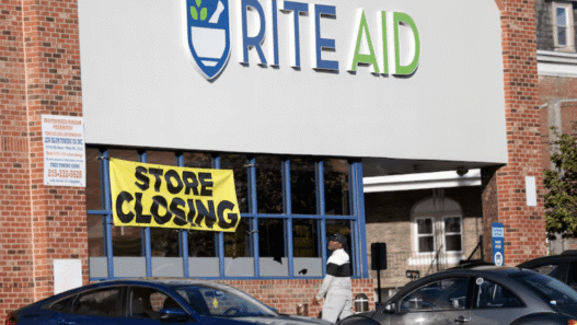 Rite Aid storefront with closing signs in windows amid bankruptcy announcement