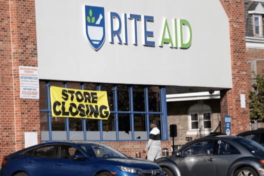 Rite Aid storefront with closing signs in windows amid bankruptcy announcement