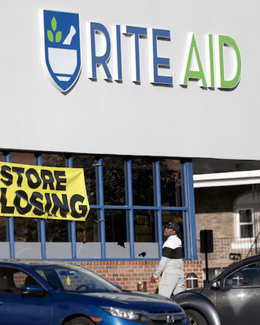 Rite Aid storefront with closing signs in windows amid bankruptcy announcement