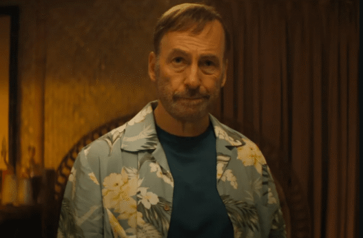 Bob Odenkirk as Hutch Mansell wielding a mallet in a violent action scene from the Nobody 2 trailer.