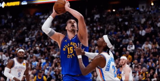 Shai Gilgeous-Alexander drives past Nikola Jokić during the 2025 NBA Playoffs as MVP rumors swirl.