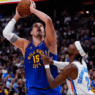 Shai Gilgeous-Alexander drives past Nikola Jokić during the 2025 NBA Playoffs as MVP rumors swirl.