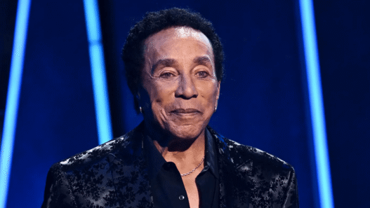 Smokey Robinson and his wife Frances Robinson at a public event, amid new sexual assault lawsuit allegations from former employees.