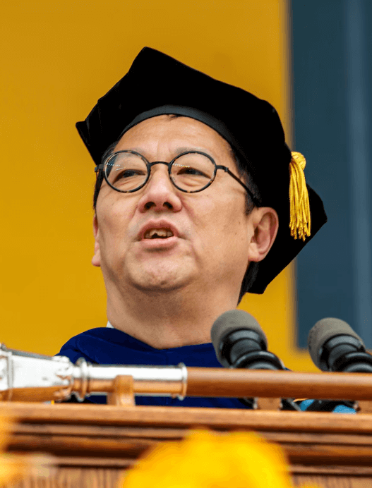 Santa Ono speaking at a podium during a University of Michigan event.