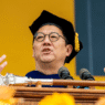 Santa Ono speaking at a podium during a University of Michigan event.