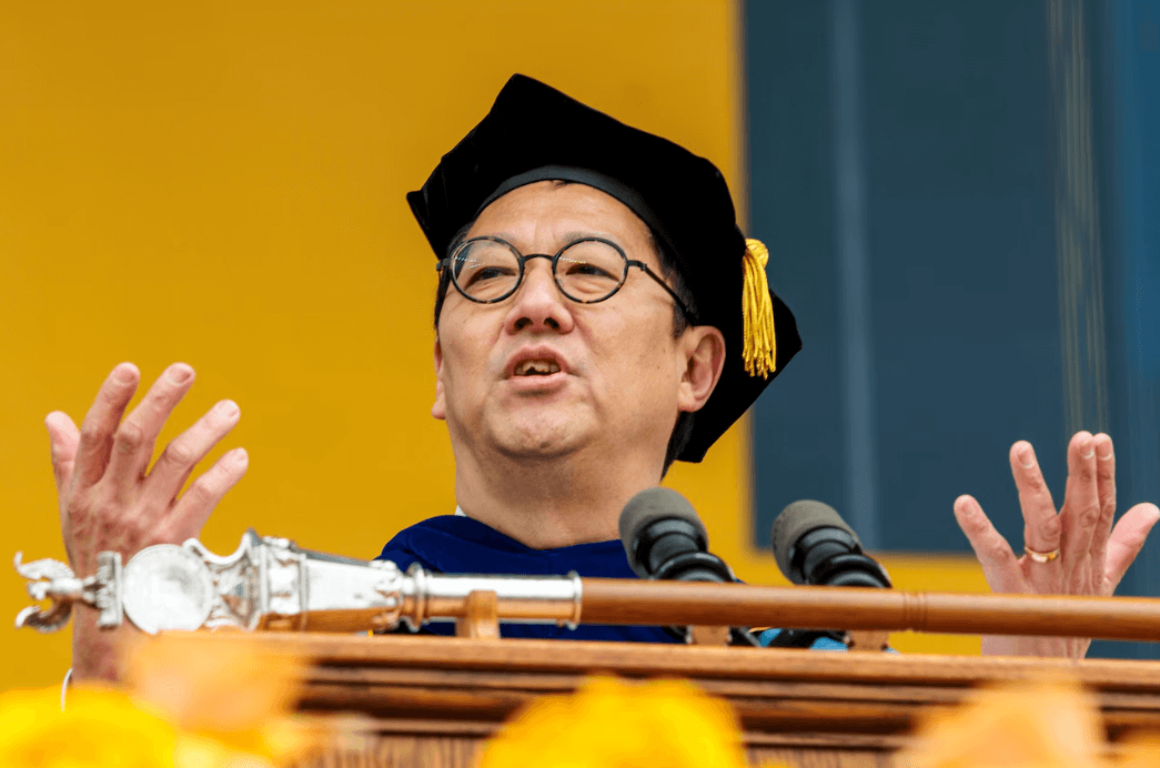 Santa Ono speaking at a podium during a University of Michigan event.