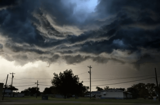Dark storm clouds gather over Texas Hill Country as NWS issues tornado and severe thunderstorm warnings.