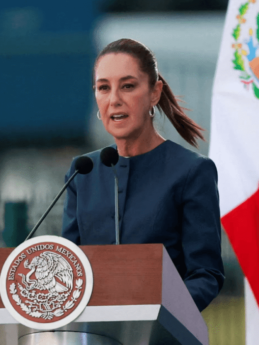 Mexican President Claudia Sheinbaum speaking at a podium during a press conference