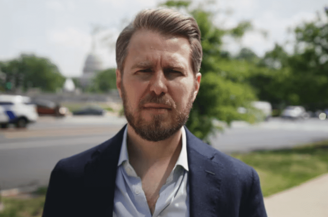 Miles Taylor speaking during a televised interview about Trump and government retaliation