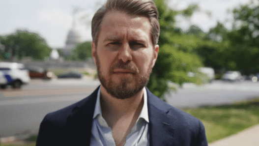 Miles Taylor speaking during a televised interview about Trump and government retaliation