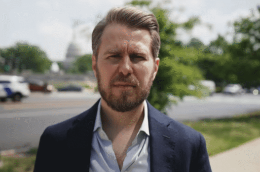 Miles Taylor speaking during a televised interview about Trump and government retaliation