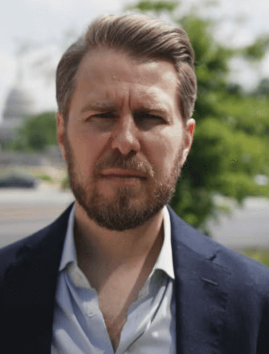 Miles Taylor speaking during a televised interview about Trump and government retaliation