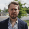 Miles Taylor speaking during a televised interview about Trump and government retaliation